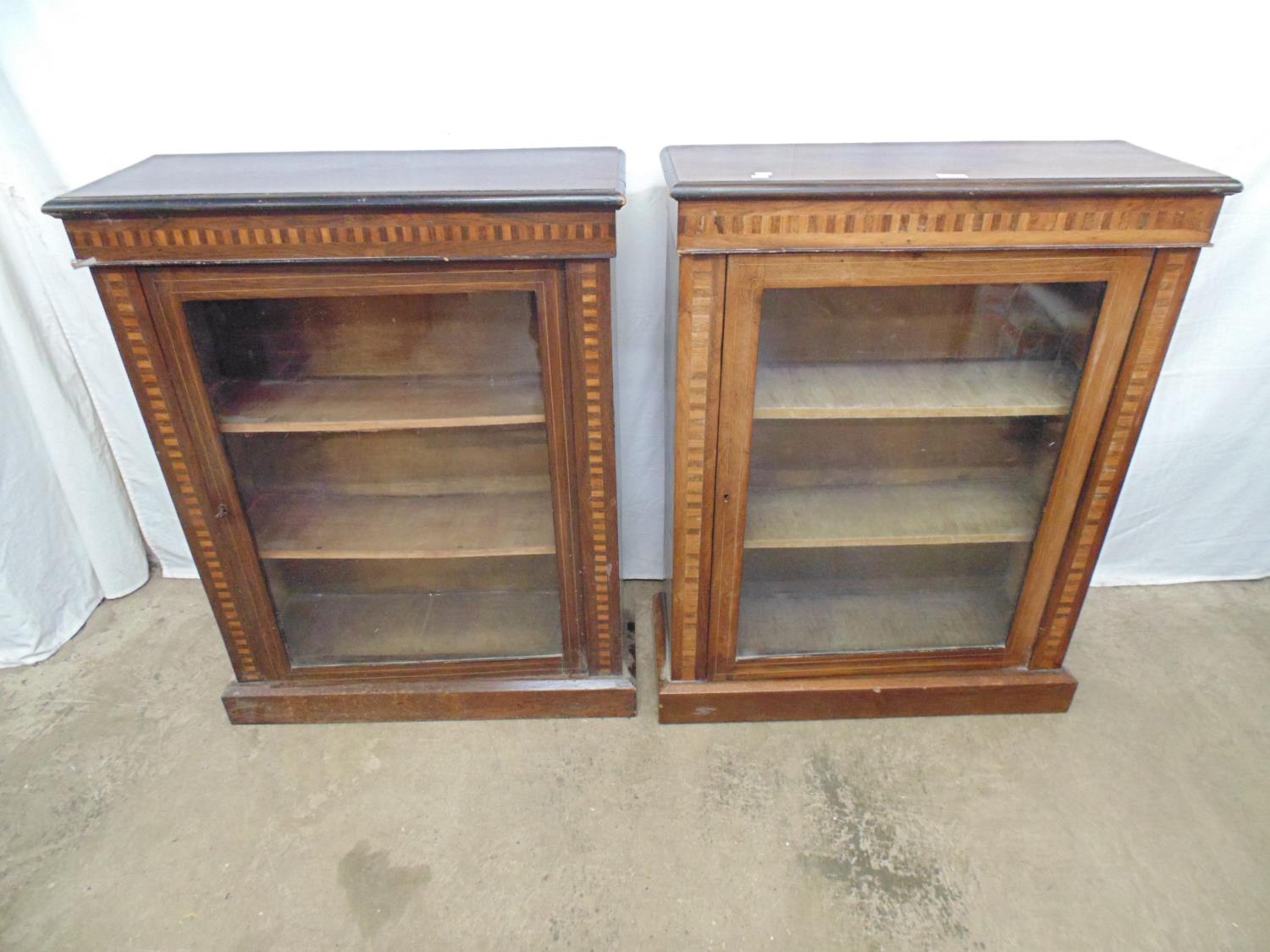 Pair of inlaid rosewood pier cabinets with banded frieze and uprights, single glazed door