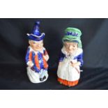 Pair of Staffordshire Toby jugs in the form of Punch and Judy complete with hat formed lids - 28cm