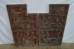 Pair of carved hardwood possibly African panels having decoration of figures - 66cm x 102cm x 4cm