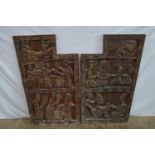 Pair of carved hardwood possibly African panels having decoration of figures - 66cm x 102cm x 4cm