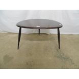 Dark Ercol Pebble table with three splay legs - 66cm x 45cm x 41cm tall Please note descriptions are