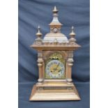 Walnut cased mantle clock of architectural style having brass face with silvered chapter ring, black