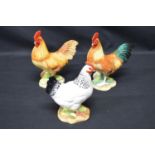 Two John Beswick figures of cockerels - 14cm tall together with a John Beswick figure of a hen -