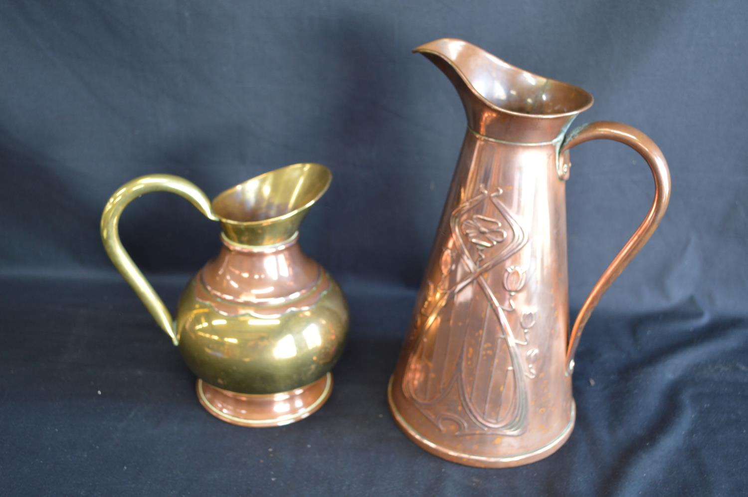 JS & S Art Nouveau copper embossed jug - 29cm tall together with one other smaller brass and