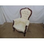 Reproduction button back armchair having cream/white upholstery, standing on cabriole front legs -