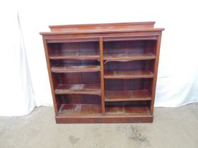 Victorian mahogany two section open bookcase having raised back over flared pediment top above six
