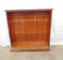 Pine open bookcase having two adjustable shelves (no shelf fixings), standing on a plinth base -