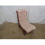 Mahogany slipper chair having buttoned pink and white upholstery, standing on scrolled legs ending