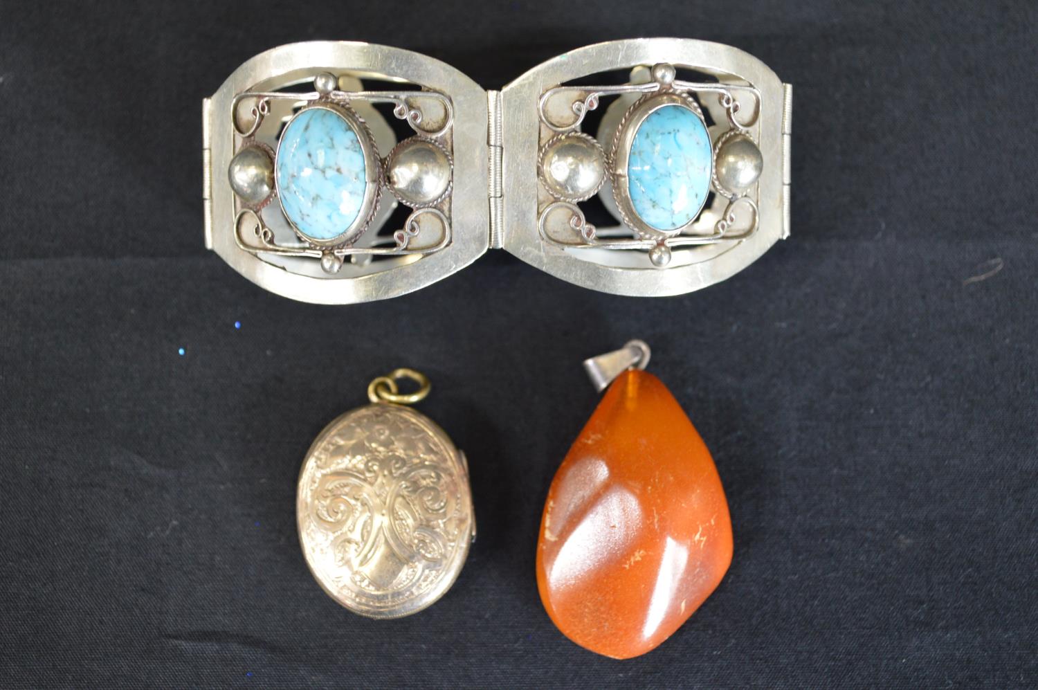 Three pieces of jewellery to comprise: Mexican white metal bracelet, yellow metal locket and amber - Image 2 of 2