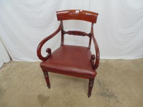 Mahogany elbow chair having bar back, carved middle rail, down swept scroll arms and padded red