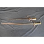 Wood and brass bayonet No. 45013 - 49cm long together with one other brass handled bayonet - 68cm