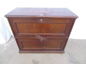 Mahogany cabinet having a panelled moulded fall front to both the top and base, standing on plinth