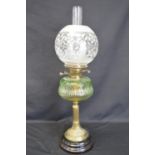 Victorian oil lamp having green glass reservoir supported on brass reeded column and having globular