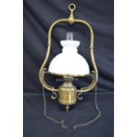 Brass framed oil lamp having domed white glass shade - 36cm wide x 67cm tall approx Please note
