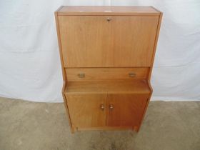 Mid century teak Remploy bureau the fall front opening to reveal storage space with central shelving