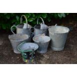 Four galvanised buckets together with two galvanised watering cans Please note descriptions are