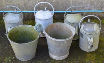 Four galvanised watering cans and two buckets Please note descriptions are not condition reports,