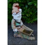 Painted resin figural planter of a gnome pushing a wheelbarrow - 35cm x 76cm tall Please note