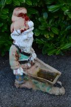 Painted resin figural planter of a gnome pushing a wheelbarrow - 35cm x 76cm tall Please note