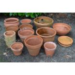 Group of twelve terracotta plant pots together with three dishes of various sizes - largest 39cm x
