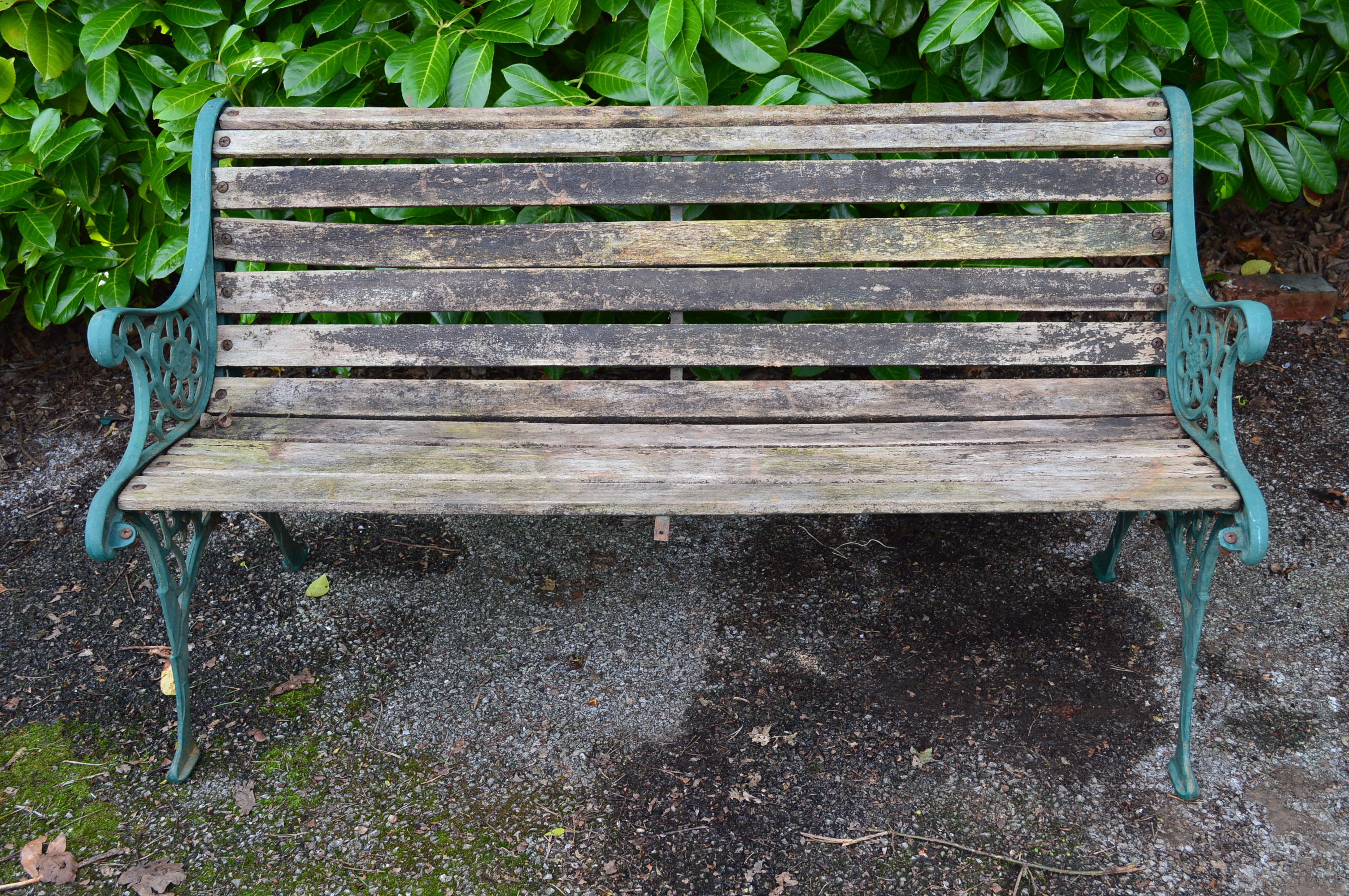 Wooden slatted garden bench with iron ends