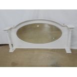 White painted bevel edge overmantle mirror having arched top with oval mirror flanked by turned