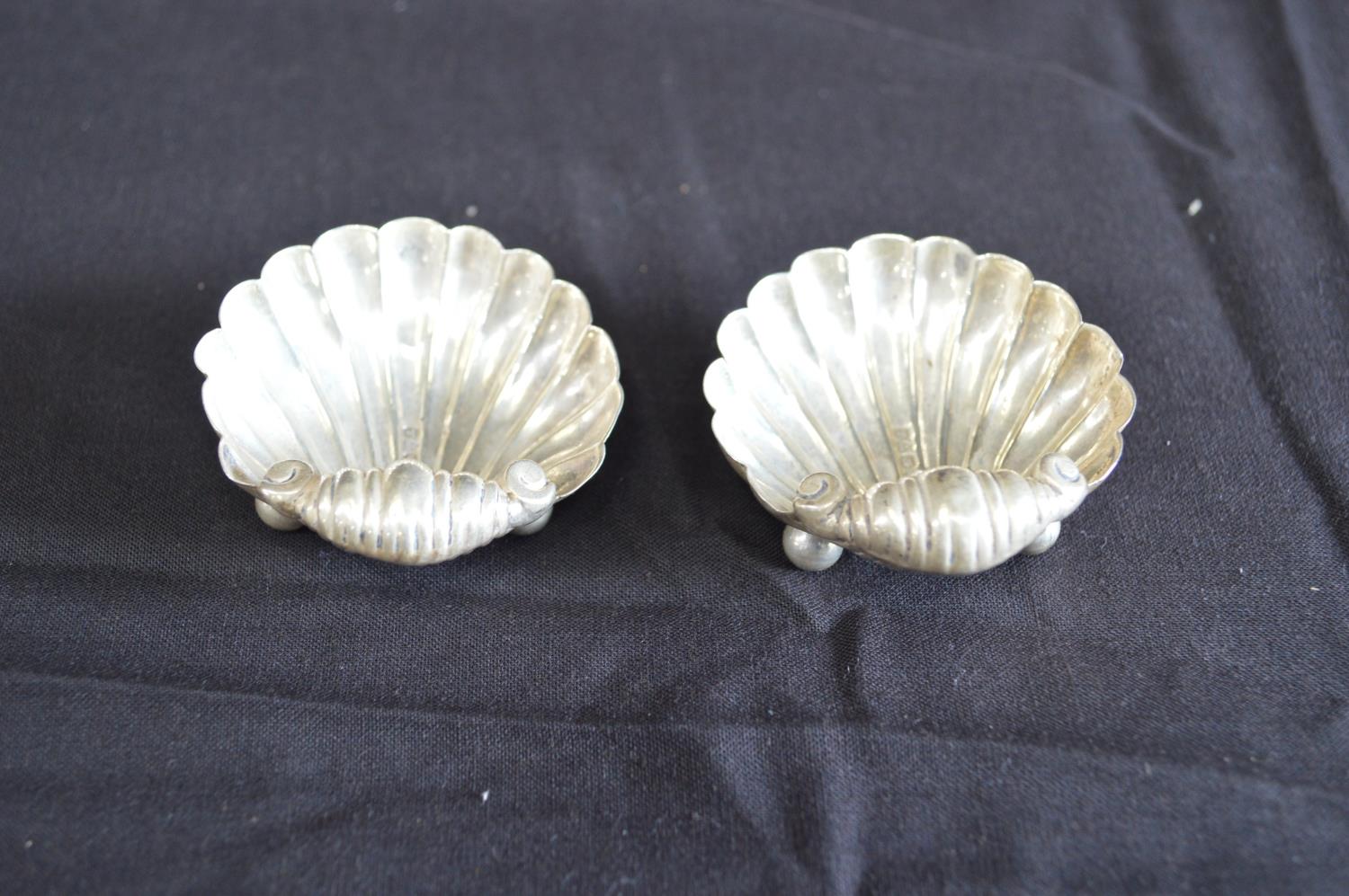 Pair of shell formed silver salts each standing on ball and ball feet, hallmarked for Chester (0.