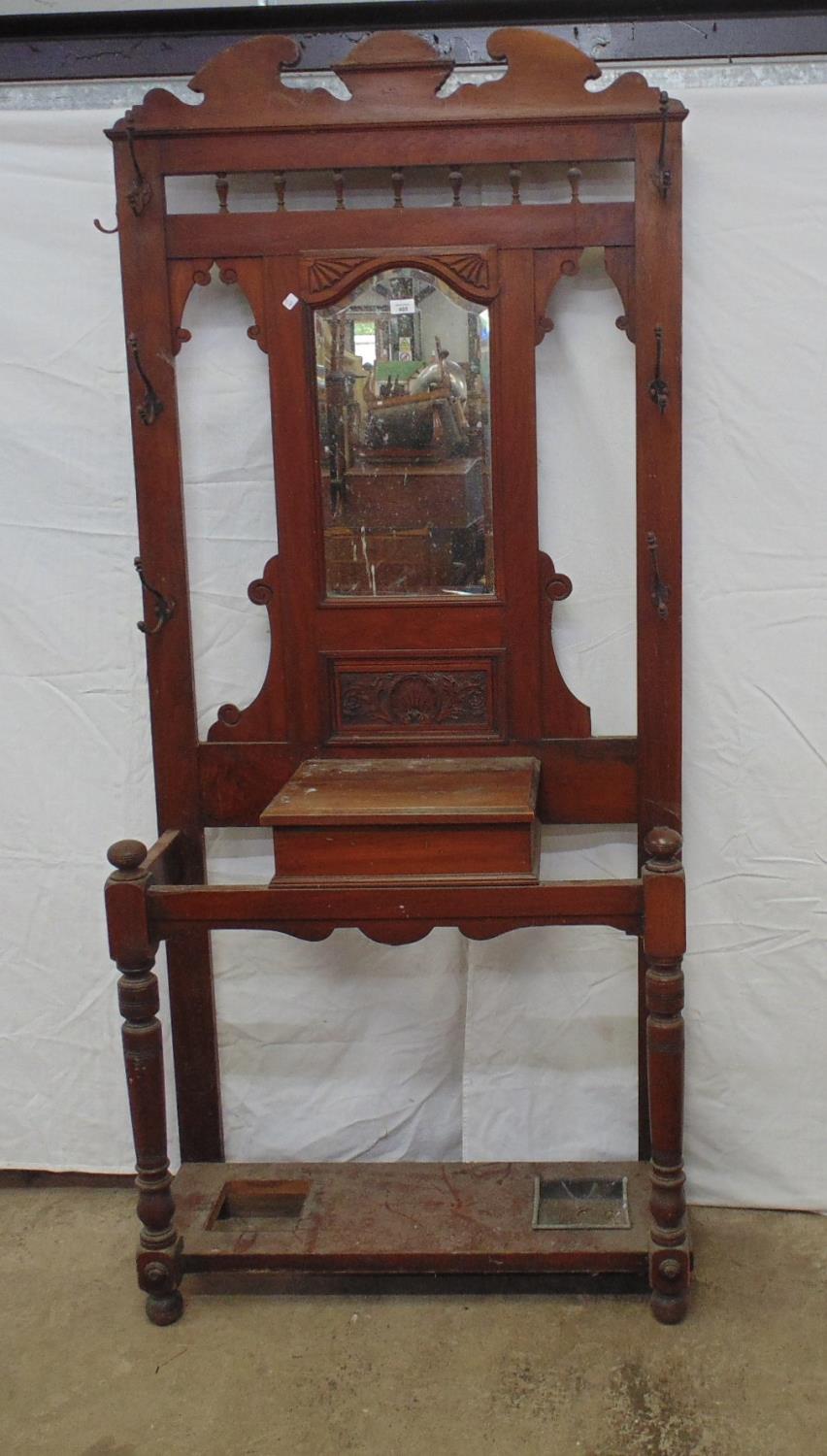 19th century mahogany hall standing having seven hooks (some side hooks missing), a central mirror