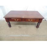 Modern mahogany coffee table having two short drawers, standing on turned legs - 131cm x 70cm x 53cm