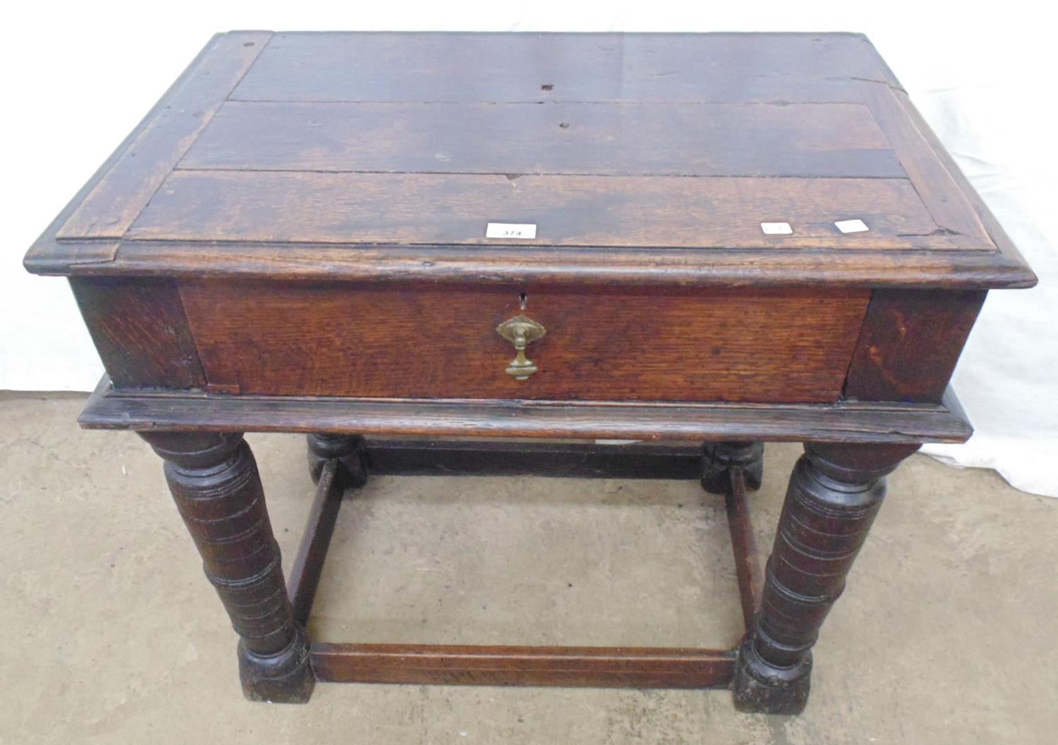 Period oak side table the rectangular top over a single drawer, standing on turned legs with cross
