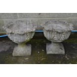 Pair of acanthus/cabbage leaf formed urns standing on square bases - 48.5cm x 41cm tall Please