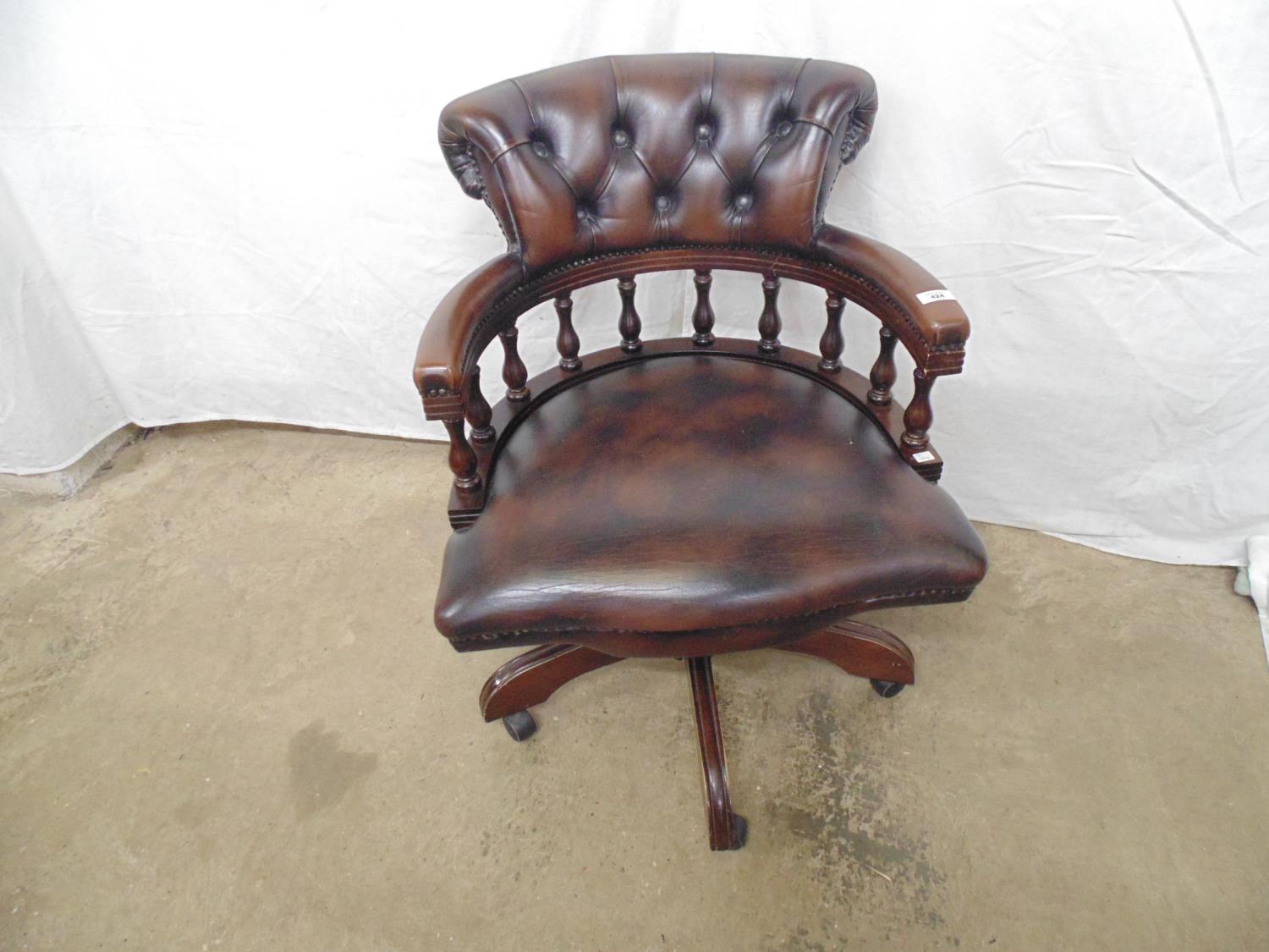 Reproduction Captains chair having buttoned leather back with padded seats and arms turned