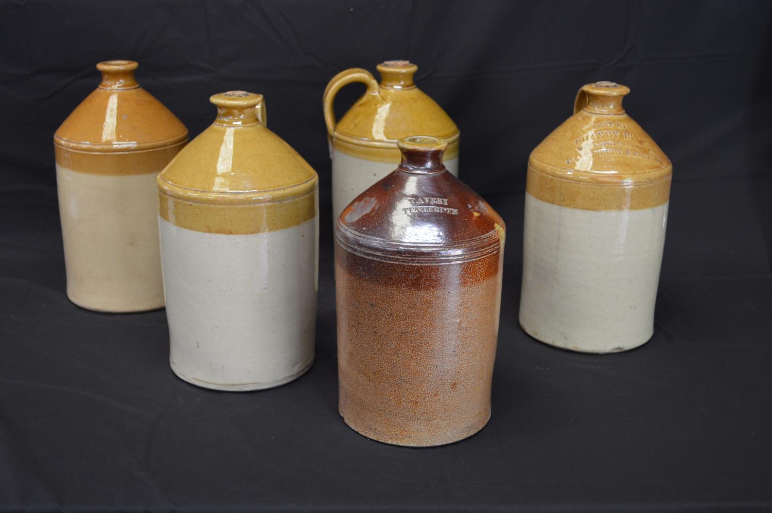 Group of five stoneware flagons to comprise: Shaxby Bros Wine & Spirit Merchants, Canterbury &