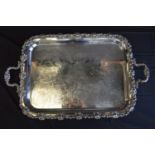 Silver plated engraved two handled serving tray with grape vine decorated border, standing on four