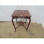 Mahogany occasional table the shaped square top over a fretwork and carved frieze with second tier