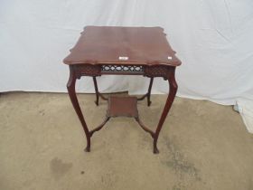 Mahogany occasional table the shaped square top over a fretwork and carved frieze with second tier