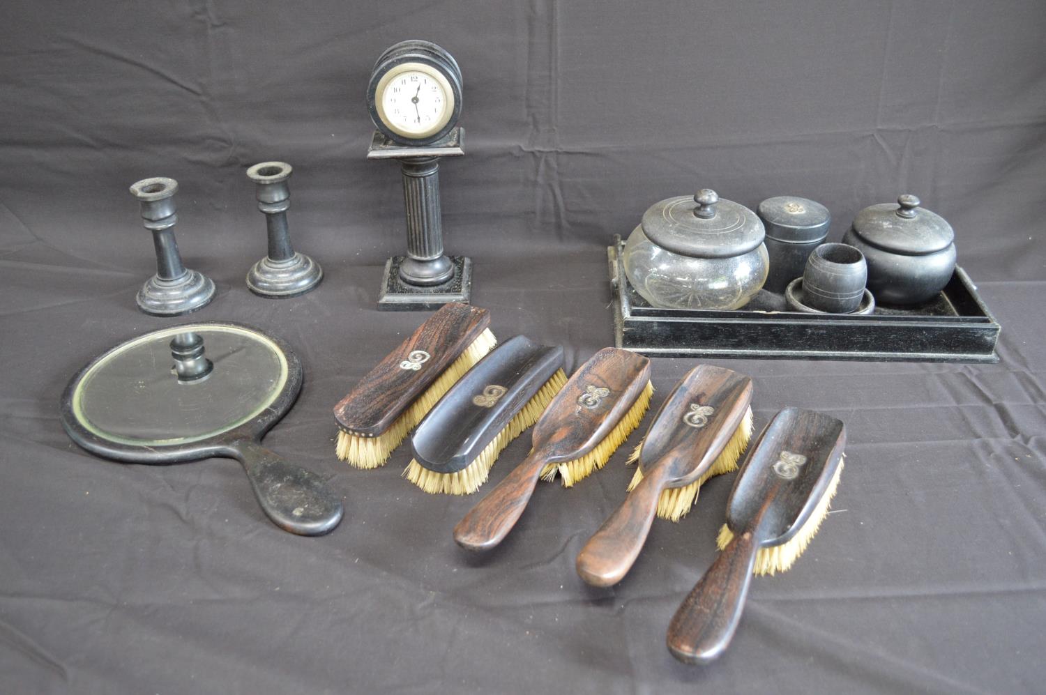 Group of ebony dressing table items to include: hand mirror, brushes, pots and clock etc Please note