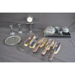 Group of ebony dressing table items to include: hand mirror, brushes, pots and clock etc Please note