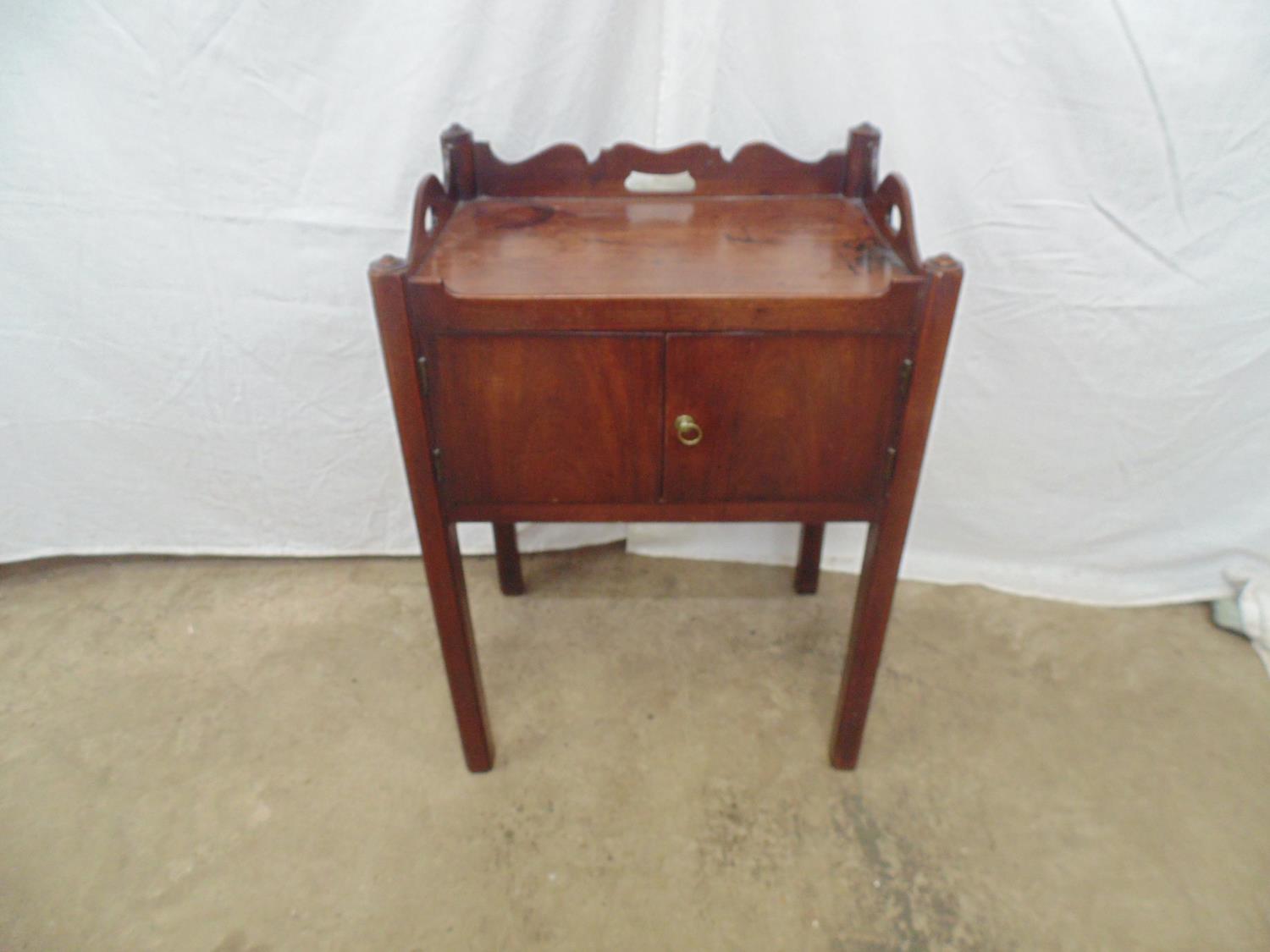Mahogany tray to commode having three pierced carrying handles over two cupboard doors, standing