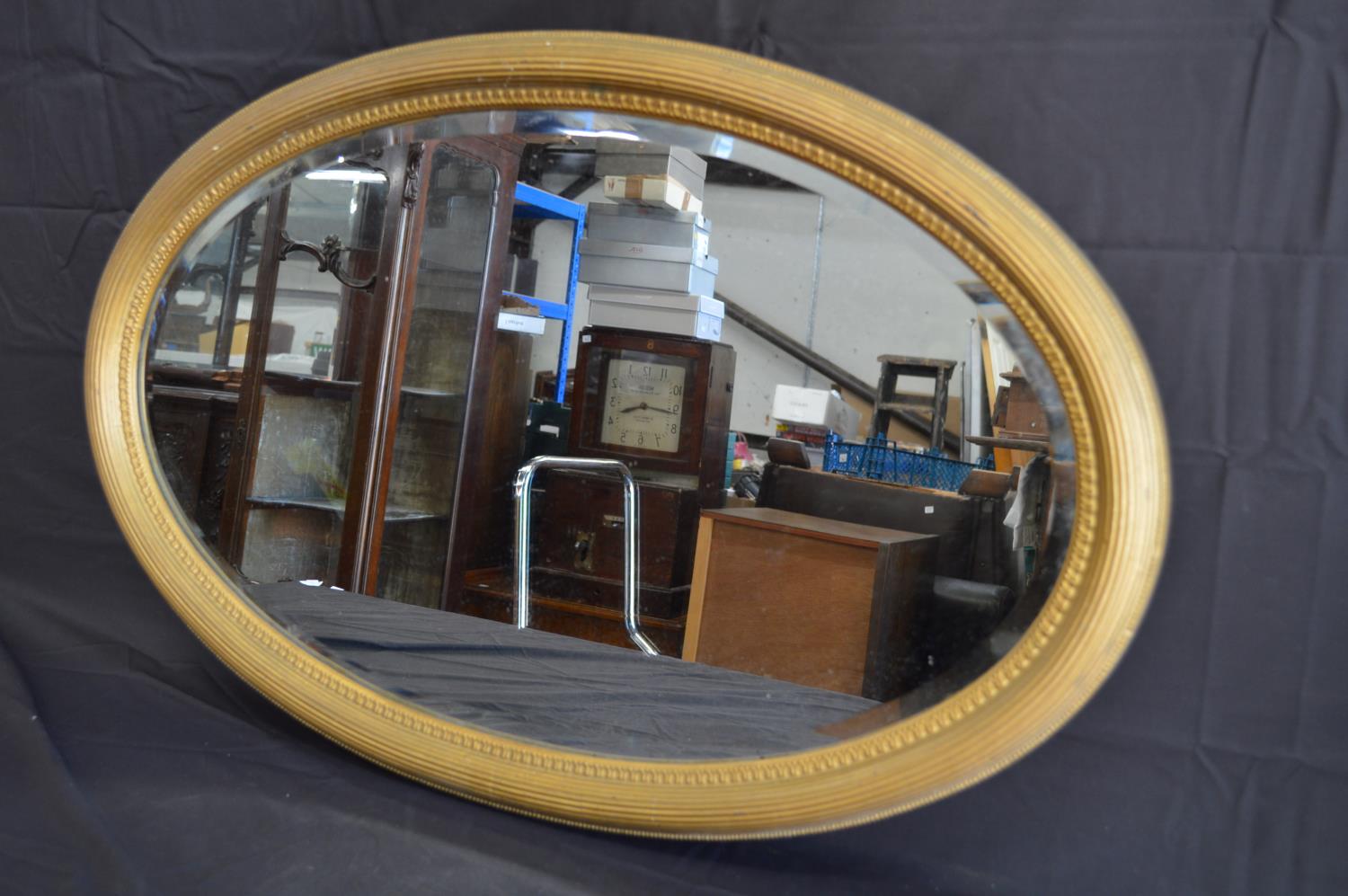 Oval reeded gilt framed wall mirror - 85cm x 55cm Please note descriptions are not condition