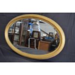 Oval reeded gilt framed wall mirror - 85cm x 55cm Please note descriptions are not condition