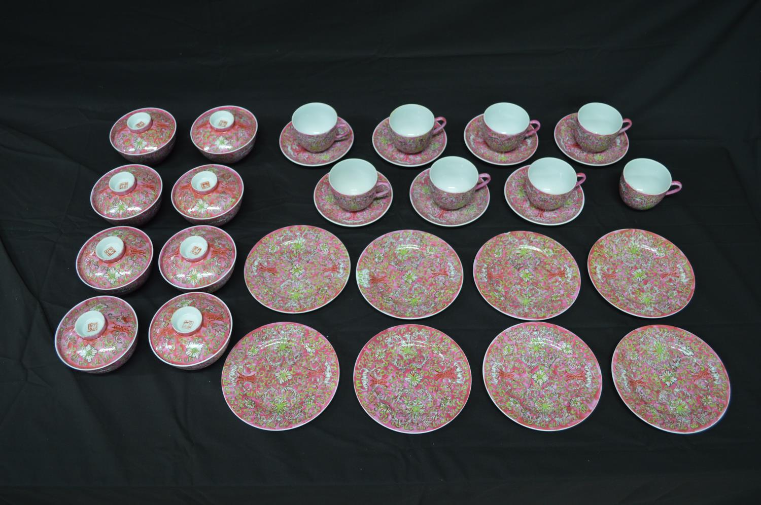 Late 20th century Chinese style tea and dinner service having foliate decoration on a pink ground to