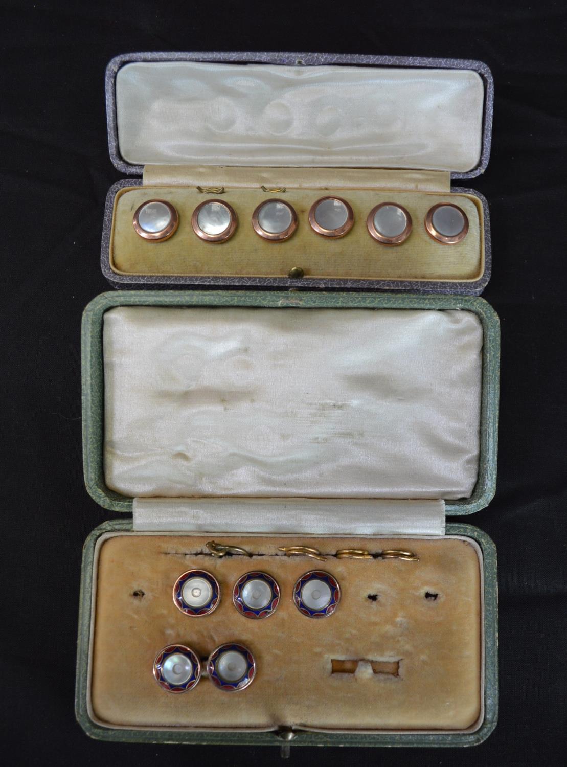 Cased set of six yellow metal and Mother of Pear buttons (four fasteners missing) together with