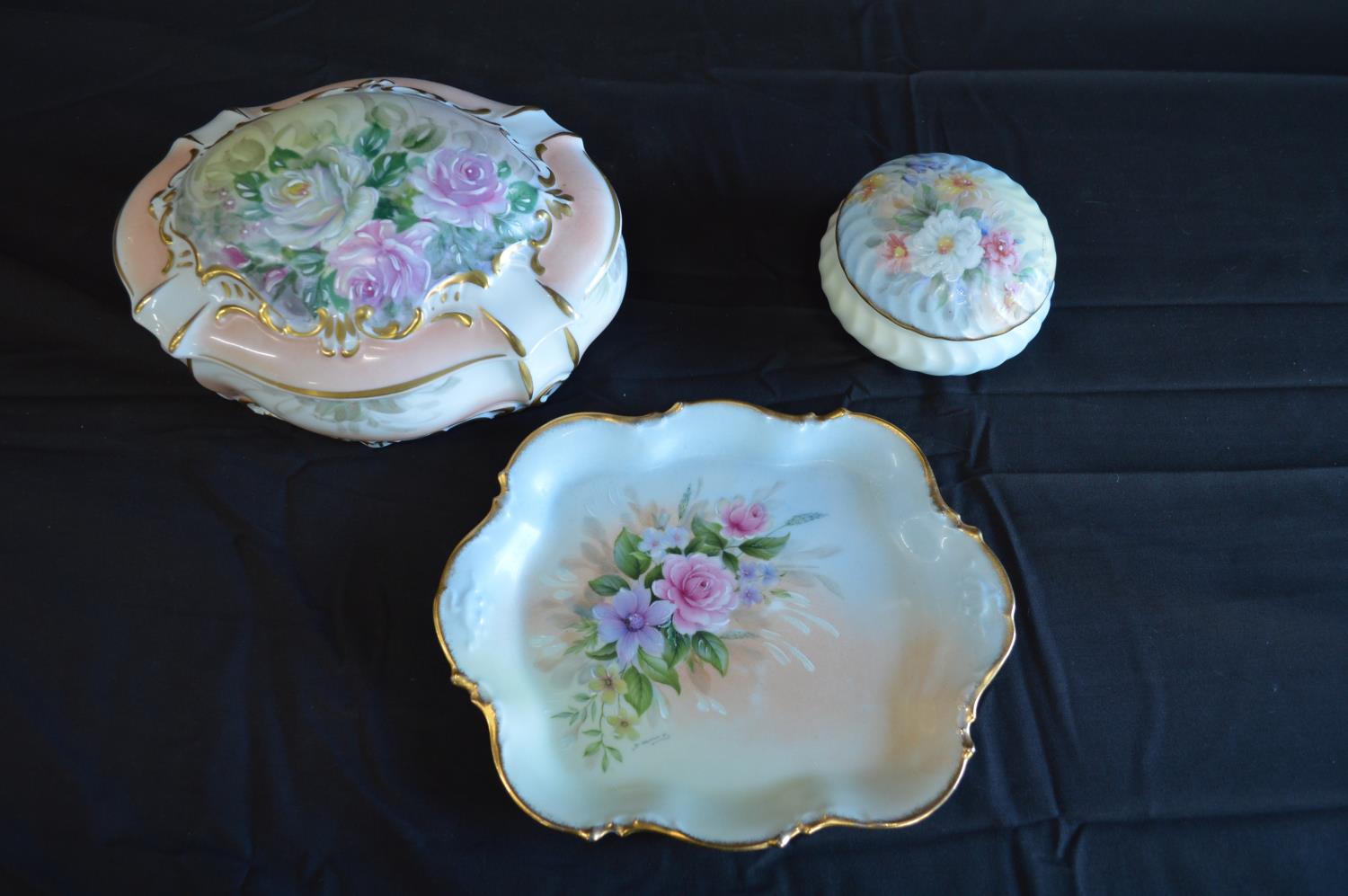 Three pieces of Limoges dressing table china to comprise: circular lidded pot - 10cm dia, oval