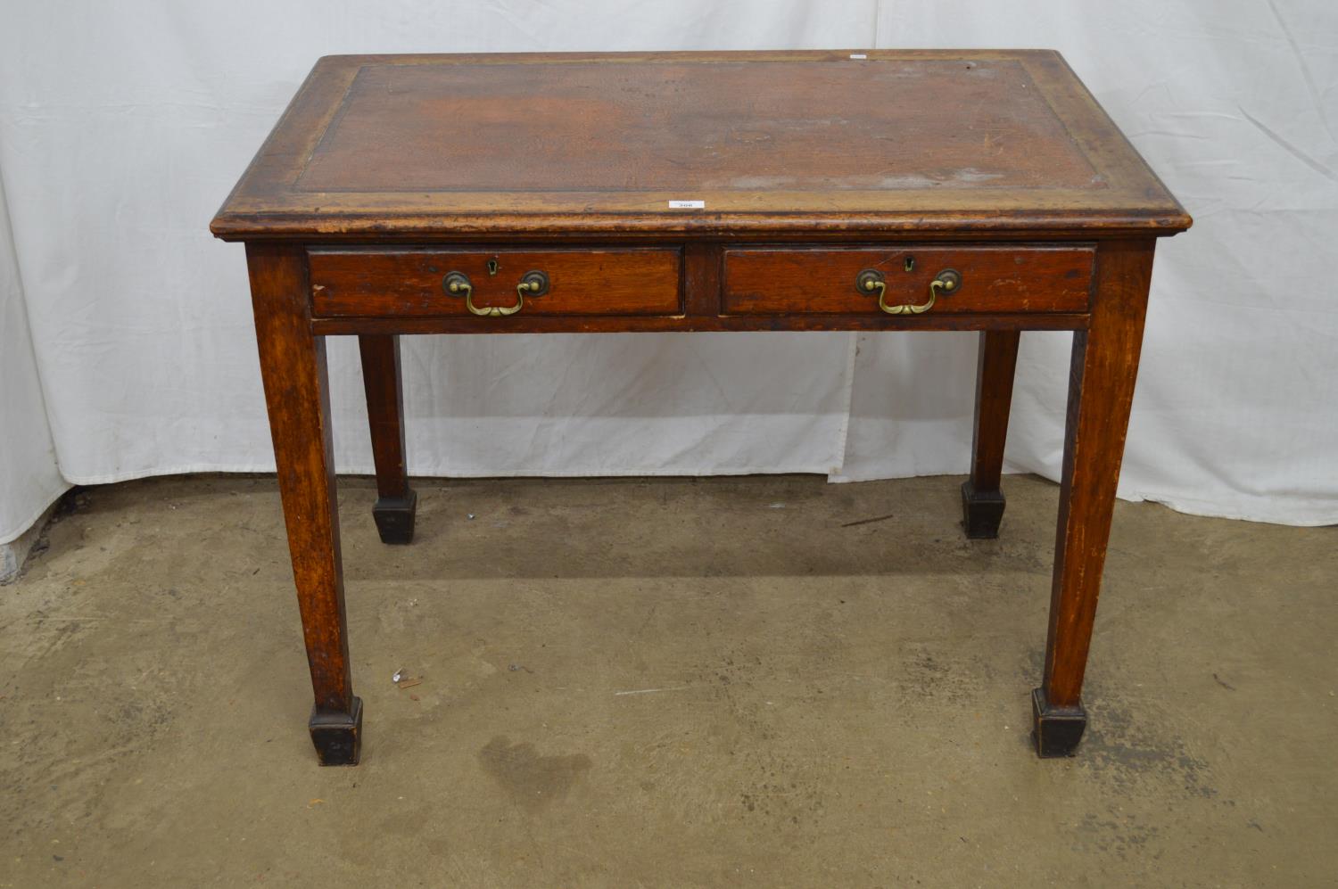 Mahogany two drawer writing table with leatherette insert, standing on square tapering legs - 106.