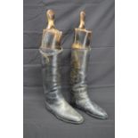 Pair of black leather riding boots with wooden trees Please note descriptions are not condition