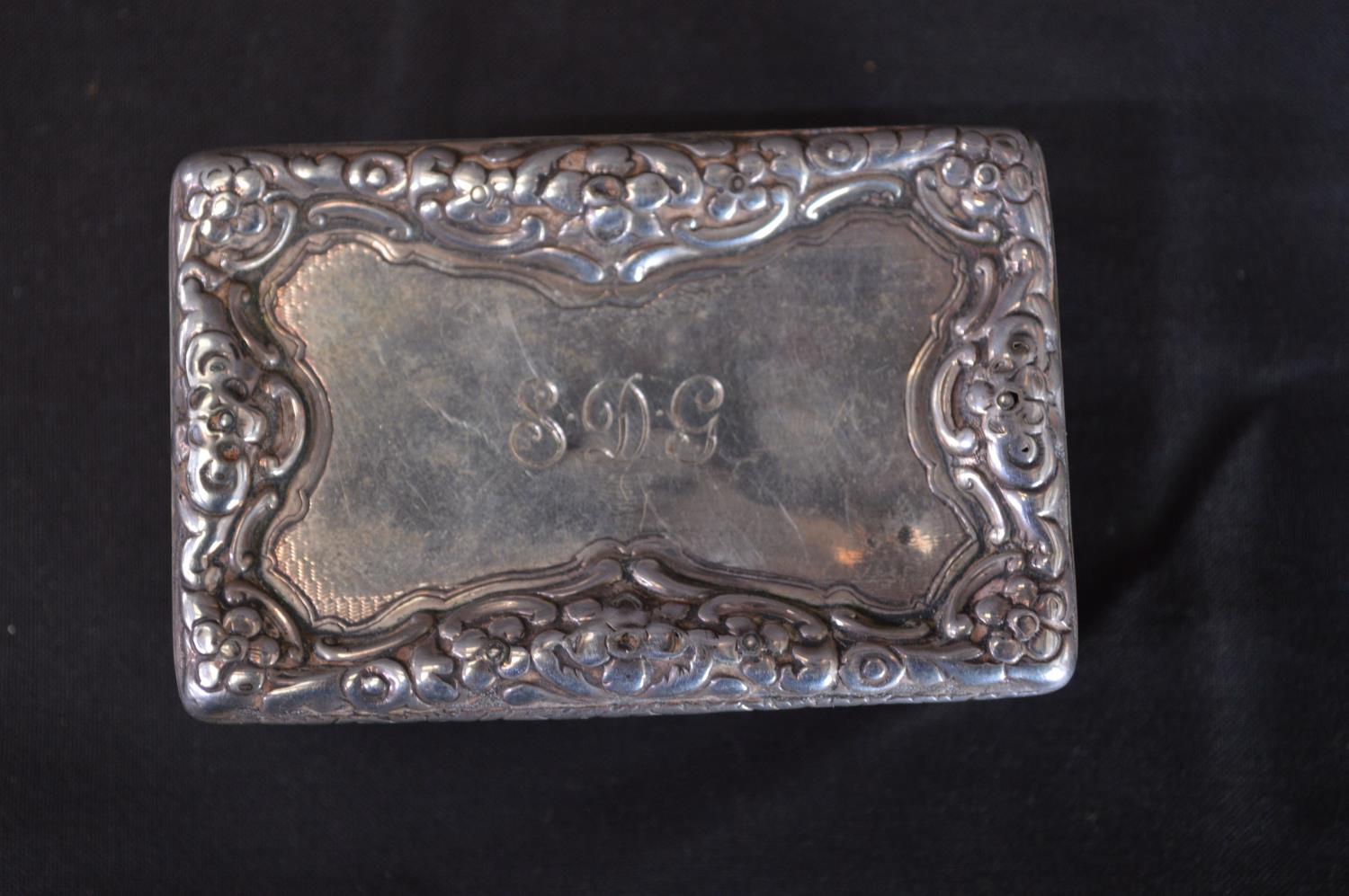 Georgian silver snuff box having floral decoration and personalised engraving, the inside having a