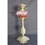 Brass based oil lamp with pink glass reservoir - 54cm tall Please note descriptions are not