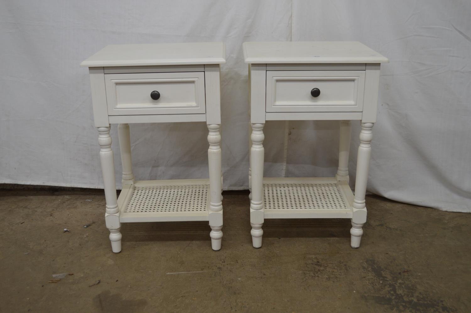 Pair of painted modern bedside tables having single drawers supported on turned columns leading to