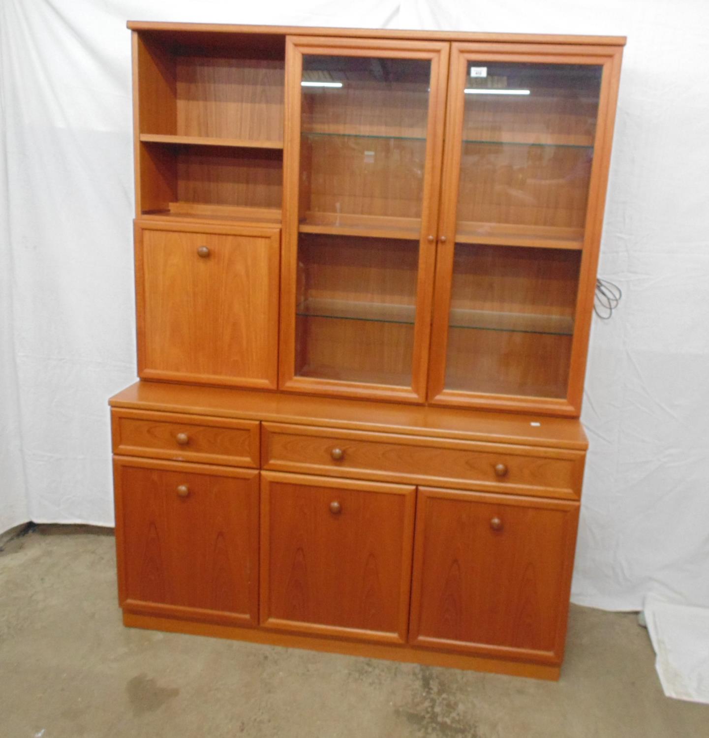 G-Plan wall unit having a glazed two door top with three fixed shelves and interior light adjacent